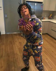 a person standing in a kitchen with food on their face and holding some kind of bag