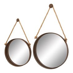 two round mirrors hanging from rope on white background