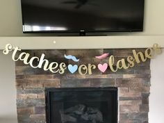 a fireplace with a sign that says taches or lashes hanging from the mantel