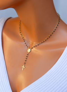 "This is a beautiful multi strand rosary inspired necklace. This lovely necklace consist of two strands, a miraculous rosary center 12x10mm and cross pendant 17x10mm. London Blue crystals measure 3x2mm, along with a shiny cable chain. Necklace is completely 14k gold filled, drop measures 2.75\". Spring clasp connects both layers in back as shown. Necklace on model is a 14\"-15\" length. Model has a small neck so please measure your neck to choose your correct length. This necklace may also be or Elegant Jewelry With Miraculous Medal And Round Beads, Rosary Inspired Necklace, Gold Rosary Necklace, 14kt Gold Jewelry, Rosary Cross, Silver Rosary, Gold Rosary, Cross Necklaces, Cable Chain Necklace