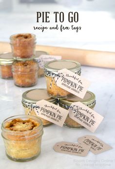 pies and tags are sitting in jars on a table with the words pie to go