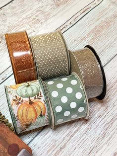 four rolls of washi tape with pumpkins and polka dots