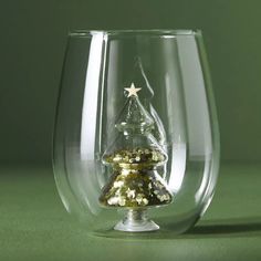 a glass with a small christmas tree in it