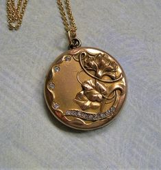 "Antique GF Locket Necklace With Flowers and Paste Stones, Art Nouveau Locket Necklace, CQ&R Gold Filled Locket; Gift for Her A pretty Art Nouveau locket is the focus of this necklace. It has a lovely repousse floral and leaf design with sparkling paste brilliants.  The locket is a beautiful example of Art Nouveau jewelry.  It is suspended from a hand-made 14k gold filled chain that measures 17 1/2 long with a 1 1/4\" extender chain. Absolutely beautiful!!  ♦ Age: Art Nouveau, Early 1900's ♦ Mak Art Deco Wedding Jewelry Locket, Art Deco Wedding Locket Jewelry, Antique Gold Art Nouveau Jewelry For Formal Occasions, Antique Gold Art Nouveau Wedding Jewelry, Elegant Ceremonial Necklaces With Vintage Charm, Elegant Vintage Charm Necklace For Ceremonial Occasions, Art Nouveau Locket, Stones Art, Nouveau Jewelry