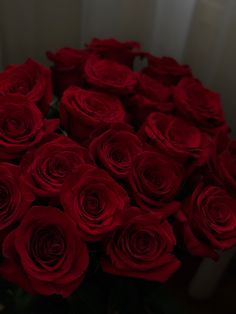 a bunch of red roses in a vase