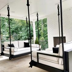 a living room with white furniture and black accents