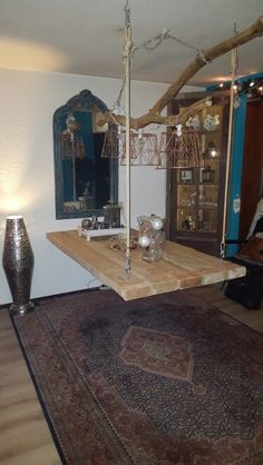 a living room filled with furniture next to a wooden table and lamp on top of a rug