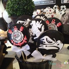 some black and white plates are sitting in a vase on a table with other decorations