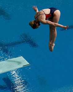 a woman diving into a swimming pool