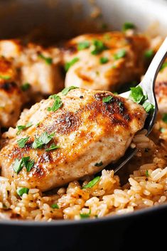 chicken and rice in a skillet with a spoon