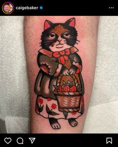 a person with a cat tattoo on their arm holding a basket full of fruit and vegetables