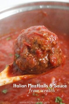 a ladle full of meatballs and sauce