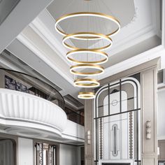 a large living room with white furniture and chandelier hanging from the ceiling above it