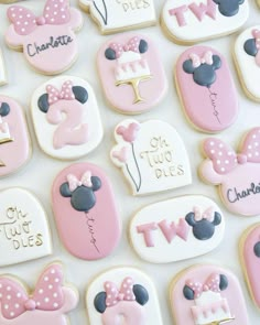 decorated cookies are arranged in the shape of mickey and minnie's first birthdays