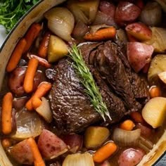 pot roast with carrots, potatoes and parsley in a pan on a table