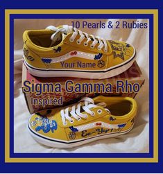 two yellow shoes with blue and white writing on them