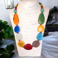 Artisanal Tagua Nut Necklace With Matching Earrings Handcrafted In Ecuador. This Is Organic Vegan Jewelry . Tagua Feels Very Nice On The Skin, It Is Dense And Durable, But Lightweight. It Looks Great With Casual Outfits And Dressy Ones. The Length Can Be Adjusted Due To The Sliding Cord Made Of Artisanal Cotton Thread Dipped Into Beewax, Which Makes It Very Strong. Tagua Is A Gift Of Nature, This Jewelry Looks Great With Dressy Clothes And Casual Ones. Buy One Today, You Will Be Very Pleased Wit Multicolor Hand Painted Round Bead Jewelry, Unique Green Fair Trade Jewelry, Multicolor Resin Round Jewelry, Multicolor Round Resin Jewelry, Artistic Adjustable Jewelry For Beach, Blue Artsy Jewelry For Festivals, Artsy Blue Jewelry For Festivals, Fair Trade Multicolor Jewelry For Beach, Multicolor Fair Trade Jewelry For The Beach