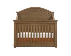 a wooden crib with white sheets and orange trim