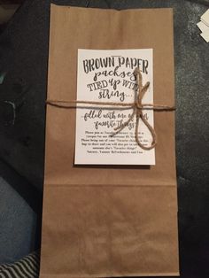 a brown paper bag tied up with twine and some writing on the label that says brown paper