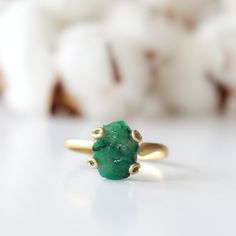 Dark green and gold create an emerald ring that sings with elegance and stands for bravery. The adjustable ring easily fits various ring sizes. The 14k gold filled metal setting creates a long-lasting and hypoallergenic ring. Each handmade pair uses a three step adhering process to guarantee durability and quality, Hypoallergenic material guarantees no reaction when you wear them. As no raw stone is the same, each emerald ring has a slightly different shape and size guaranteeing uniqueness and i Adjustable 14k Gold Emerald Ring, Green Emerald Open Ring Stackable Rings, Green Emerald Stackable Open Rings, Adjustable Green Emerald Ring For Wedding, Yellow Gold Emerald Jewelry, Adjustable Emerald Rings With Birthstone, Adjustable Yellow Gold Emerald Ring With Birthstone, Adjustable Yellow Gold Emerald Birthstone Ring, Adjustable Oval Emerald Rings