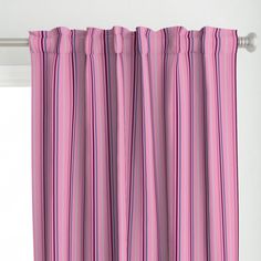 a pink and blue striped curtain hanging from a window