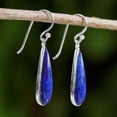 Presented by Michael Krainer of Thailand, these stunning hook earrings are set in rhodium plated sterling silver, with vibrant drops of blue lapis lazuli hanging in luxurious splendor. Rhodium plated sterling silver, sterling silver hooks, lapis lazuli Hook earrings High polish finish Rhodium-plated Handmade in & fairly traded from Thailand Due to the handmade nature of this item, color may vary slightly: Blue Polished Drop Earrings, Blue Drop Earrings With Polished Finish, Silver Lapis Lazuli Gemstone Earrings, Silver Lapis Lazuli Drop Earrings, Blue Lapis Lazuli Teardrop Earrings, Blue Teardrop Lapis Lazuli Earrings, Silver Lapis Lazuli Pierced Earrings, Elegant Silver Lapis Lazuli Earrings, Elegant Silver Earrings With Lapis Lazuli