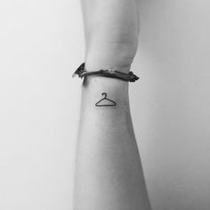 a person's arm with a small tattoo on the left side of their wrist