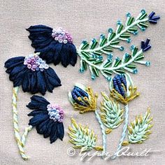 embroidered flowers and leaves on a piece of cloth