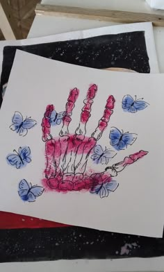 a drawing of a hand with butterflies on it