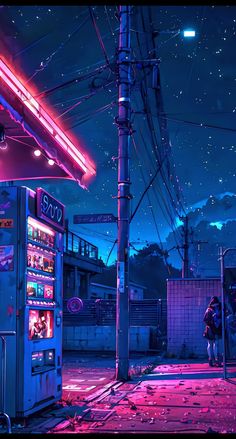 an old fashioned vending machine sitting on the side of a road at night with neon lights