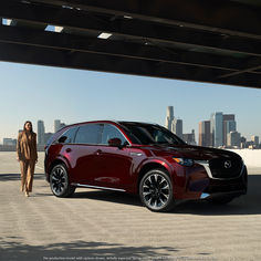 a woman walking next to a red suv