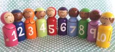 a group of wooden peg dolls sitting next to each other