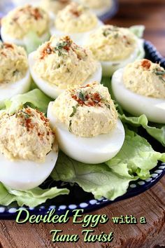 deviled eggs with tuna in lettuce on a platter, ready to be eaten