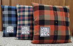 three different plaid pillows sitting on top of a counter next to each other, one has a button down closure and the other has a label that says i love you