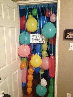 balloons and streamers are hanging from the door