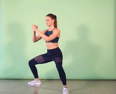 a woman in black sports bra top and leggings standing on one leg with her hands together