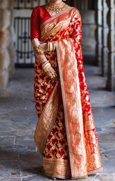 a woman in a red and gold sari