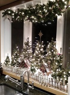 a kitchen counter topped with christmas trees and lights