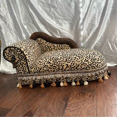 a leopard print chair with tassels and pom poms