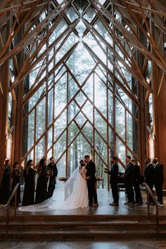 a bride and groom are standing in front of the altar