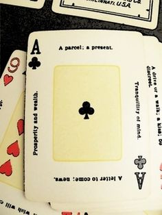 four playing cards are stacked on top of each other, with one card in the middle