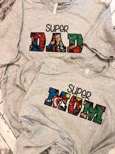 two sweatshirts with the words super mom and dad printed on them