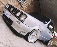 a silver car parked next to a brick building