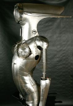 a metal sculpture of a person holding a wrench