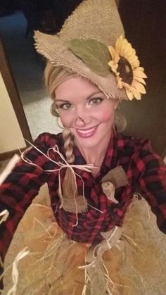 a woman with a sunflower on her hat