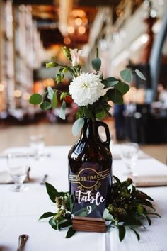 there is a vase with flowers in it on top of the table at this wedding reception