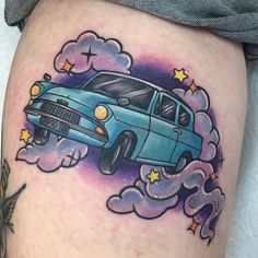 a blue car flying through the air with clouds and stars on it's thigh