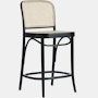 a black and white bar stool with an upholstered seat on the backrest