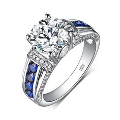 a white gold ring with blue sapphire stones and diamonds on the sides, set in 18k white gold