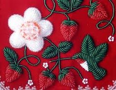 a red cloth with white flowers and strawberries on it